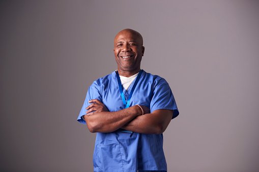 An experienced doctor in blue scrubs