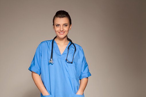 A GP in blue scrubs with a stethoscope