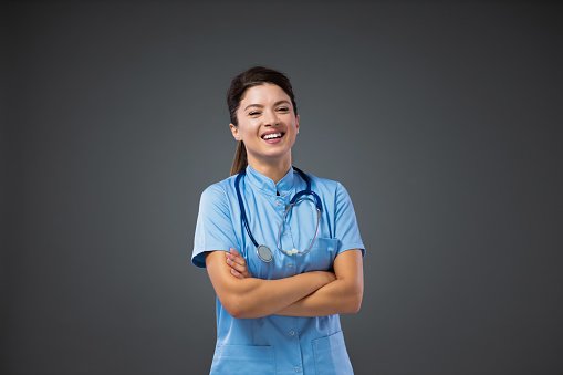 A clinician smiling with a stethoscope