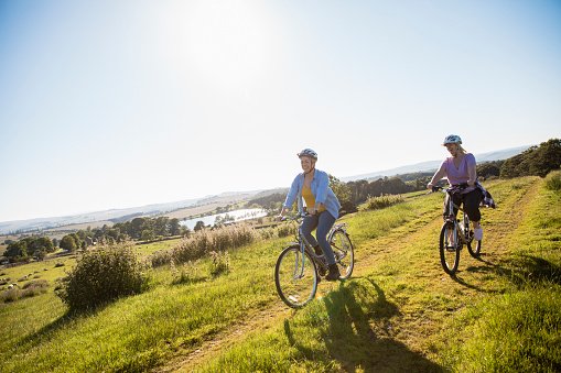 Two people cycling on a country trail