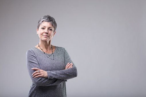 An experienced GP with arms crossed